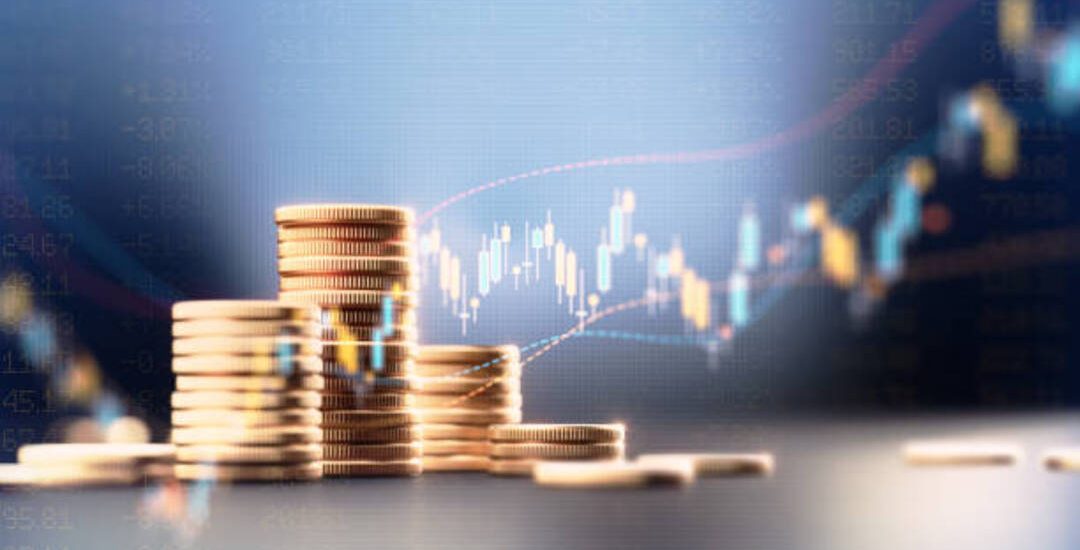 Coin stacks before blue financial graph. Horizontal composition with copy space. Business and finance concept.