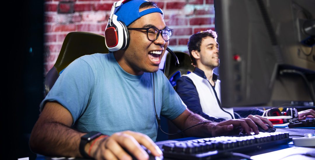 A young man gaming with his friends
