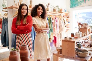 Portrait Of Two Female Sales Assistants Working In Clothing And Gift Store