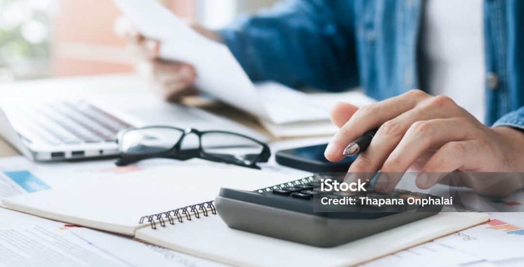 Investors are calculating profits and costs with calculators, growth and investment chart analysis, business planning and strategies to maximize sales profits. Long term business plan.