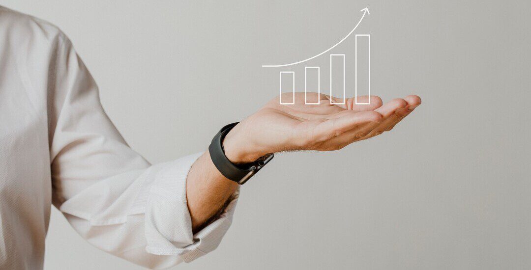 Digital increasing bar graph with businessman hand overlay