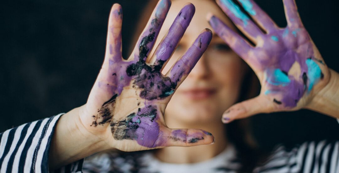 Woman artist with with painted hands
