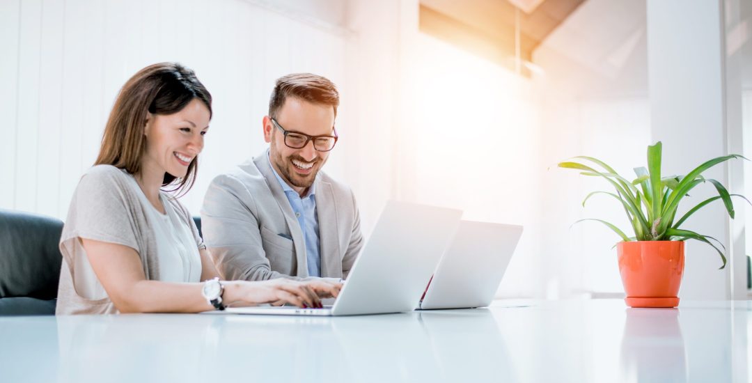 Business couple working together on project at modern startup office.