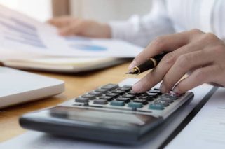 Cropped Image Of Businesswoman Working On Desk