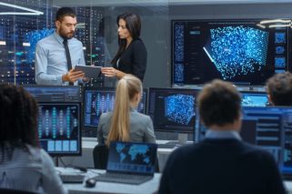 Head of the Department and Project Manager Discuss Work Process Using Data on Tablet Computer. Multi-Ethnic Team Builds Neural Network with Integrated Machine Learning.