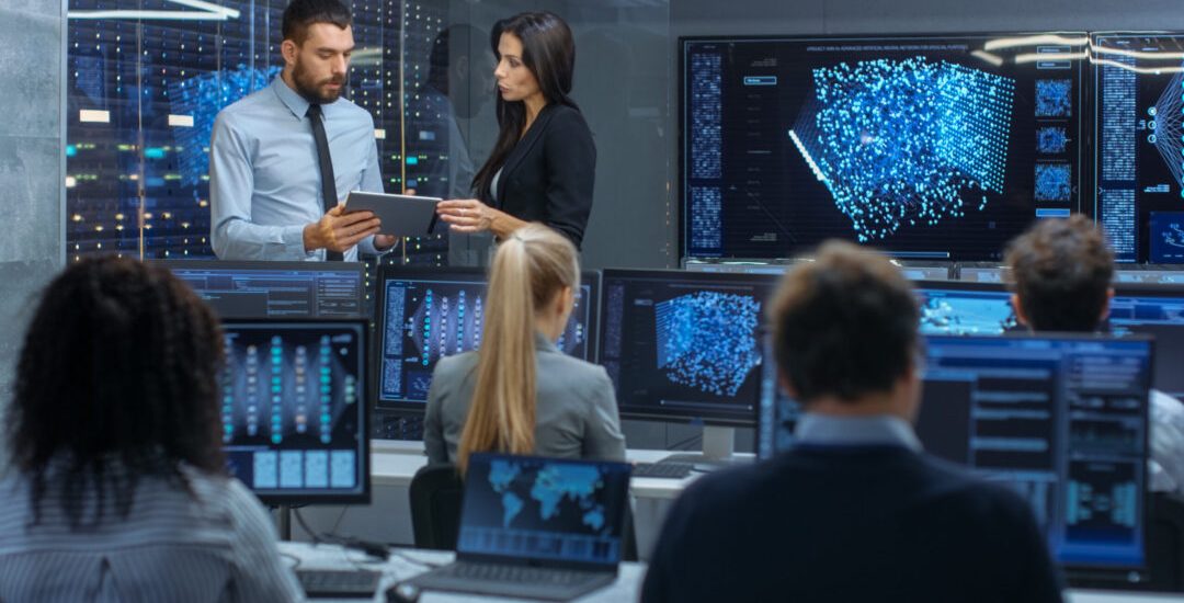 Head of the Department and Project Manager Discuss Work Process Using Data on Tablet Computer. Multi-Ethnic Team Builds Neural Network with Integrated Machine Learning.