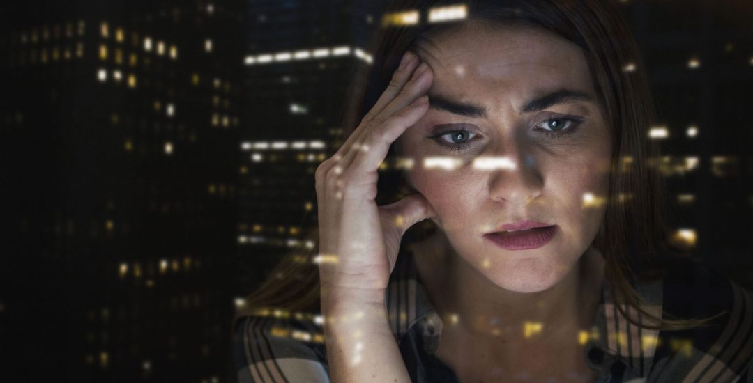Worried Caucasian businesswoman with hand on head