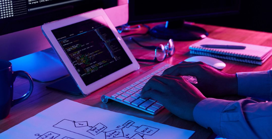 Close-up image of programmer working at his desk in office