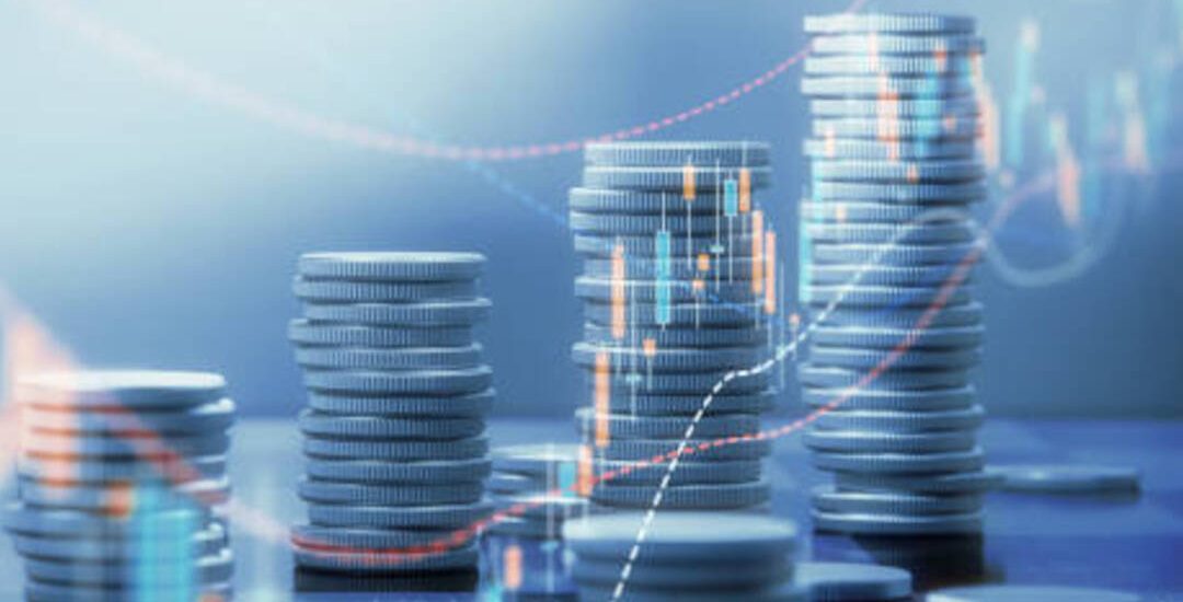 Coin stacks and chart graphs on a chessboard background. Horizontal composition with selective focus and copy space.