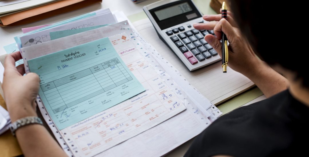 Asian woman working through paperwork