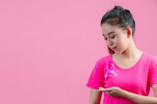 breast-cancer-awareness-woman-in-pink-t-shirt-with-satin-pink-ribbon-on-her-chest-supporting-symbolbreast-cancer-awareness
