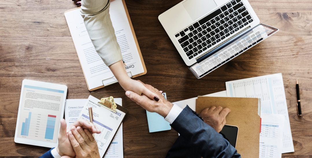 Business people shaking hands together