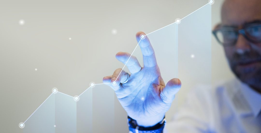 Businessman pointing his finger to a growth graph