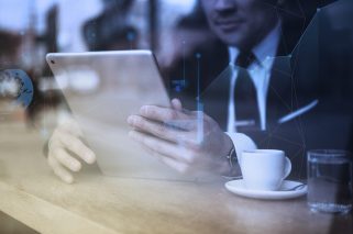 Businessman working on tablet in cafe