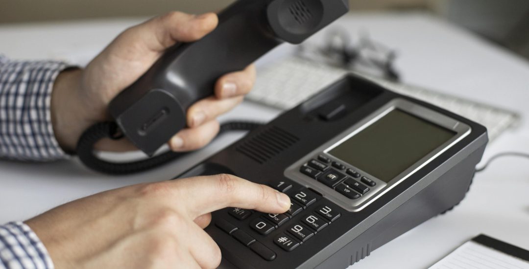 close-up-businessman-dialling-phone-number (1)