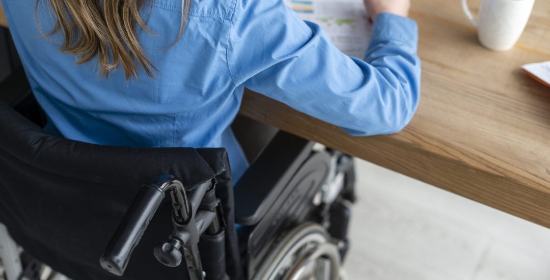 close-up-woman-wheelchair-working-office