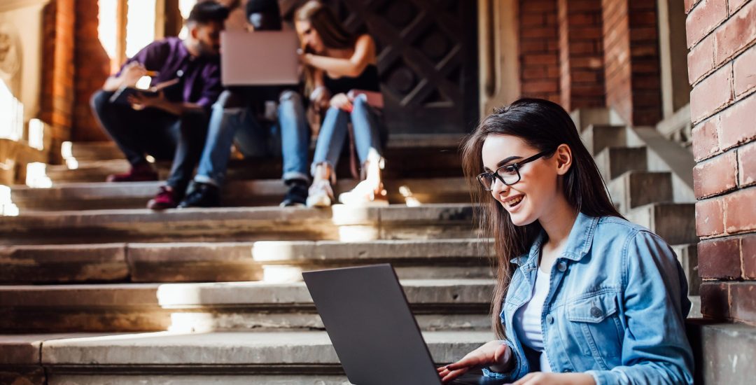 College girl working with laptop after lessons. Rest education and relax concept.