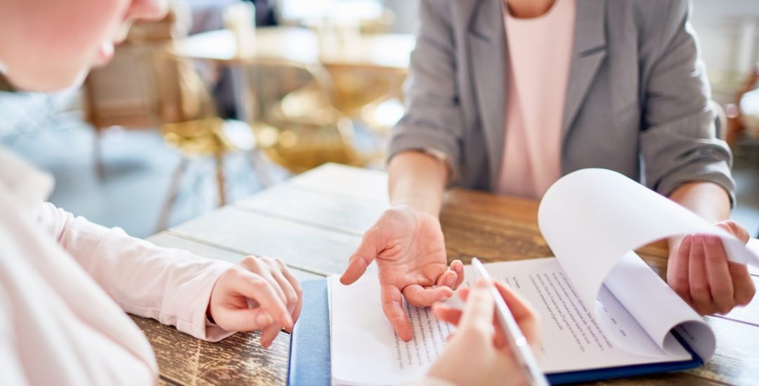 Employer explaining young applicant terms of contract during interview