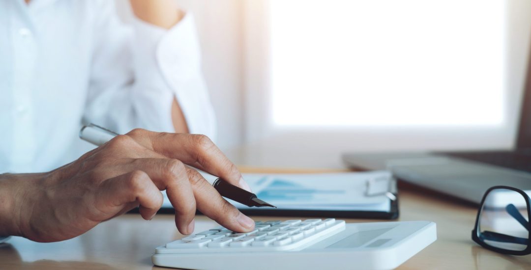 Finances Saveing Economy concept. Female accountant or banker use calculator.