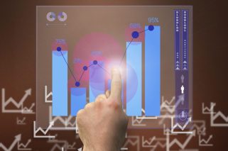 composite of hand pointing at graph with graphs in background