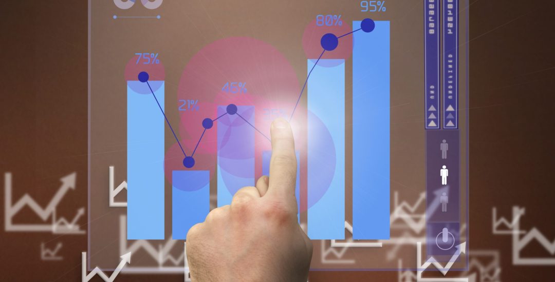 composite of hand pointing at graph with graphs in background