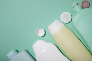 flat-lay-plastic-bottles-green-background