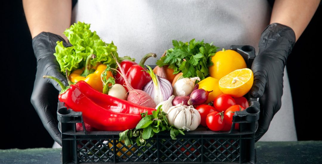 front-view-female-cook-holding-basket-with-fresh-vegetables-on-dark-food-cooking-color-salad-kitchen-cuisine