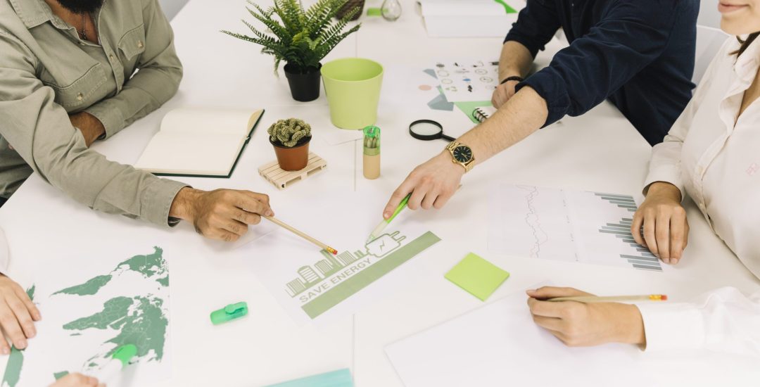 group-of-businesspeople-making-plans-on-energy-saving-at-workplace