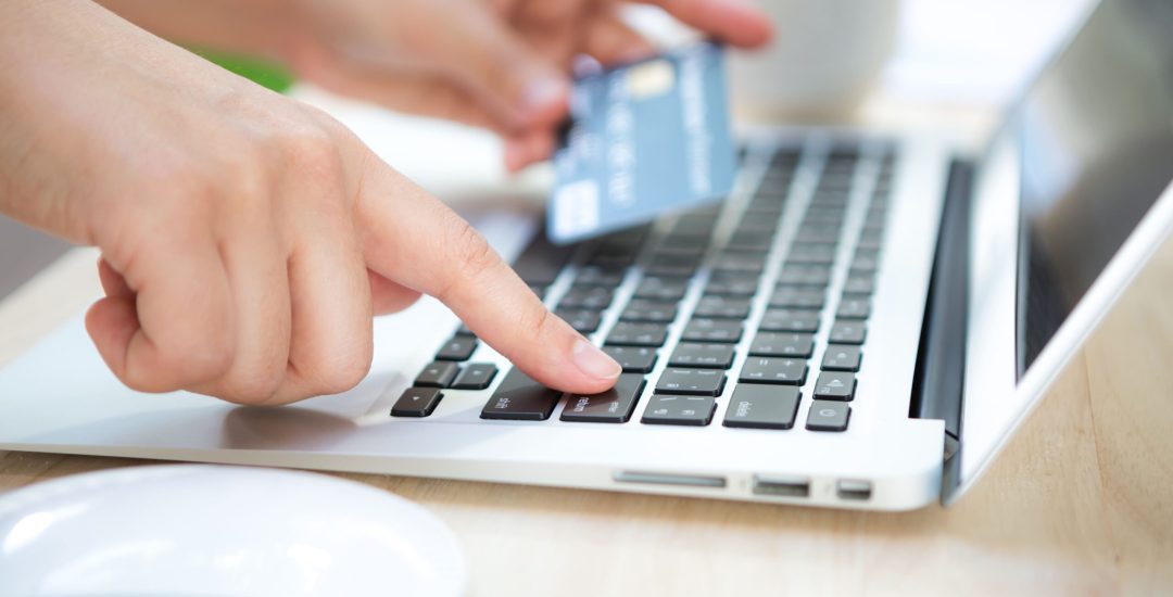 hand-with-credit-card-and-laptop (1)