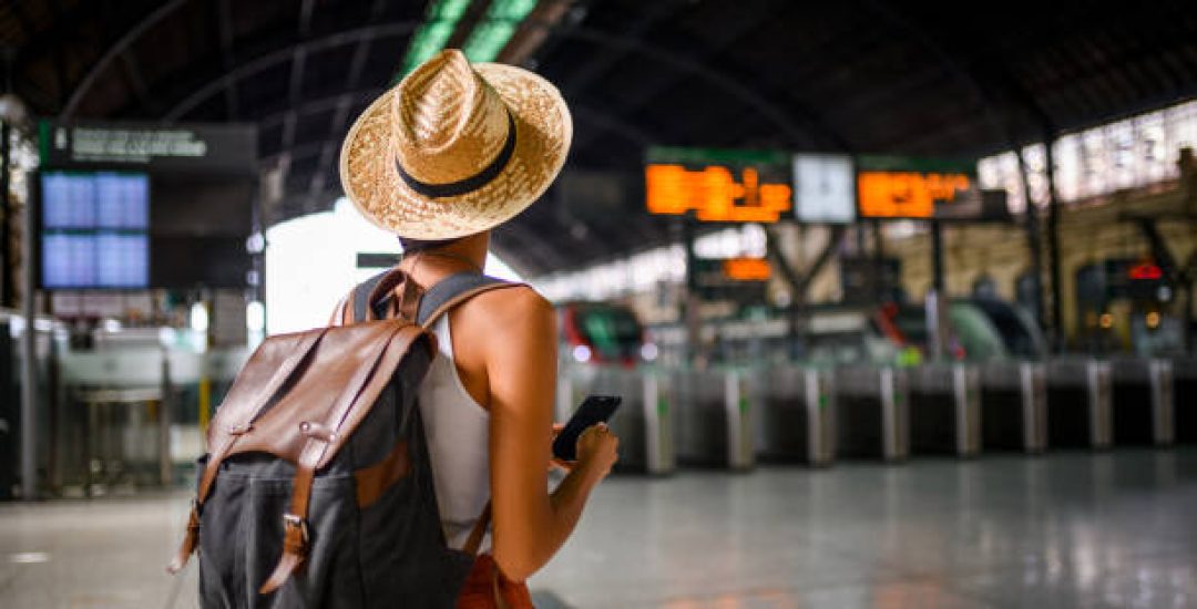 Female traveler at the train station waiting for her train.