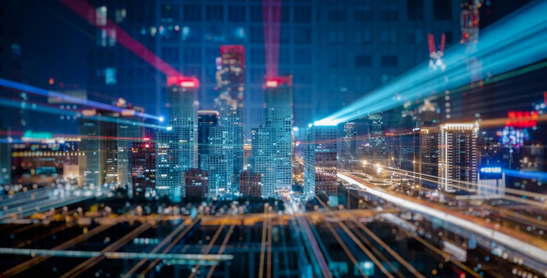Light trails above buildings at night in China.
