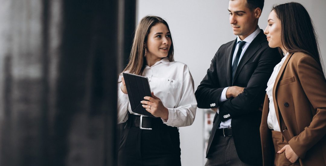 Male and female business people working on tablet in office