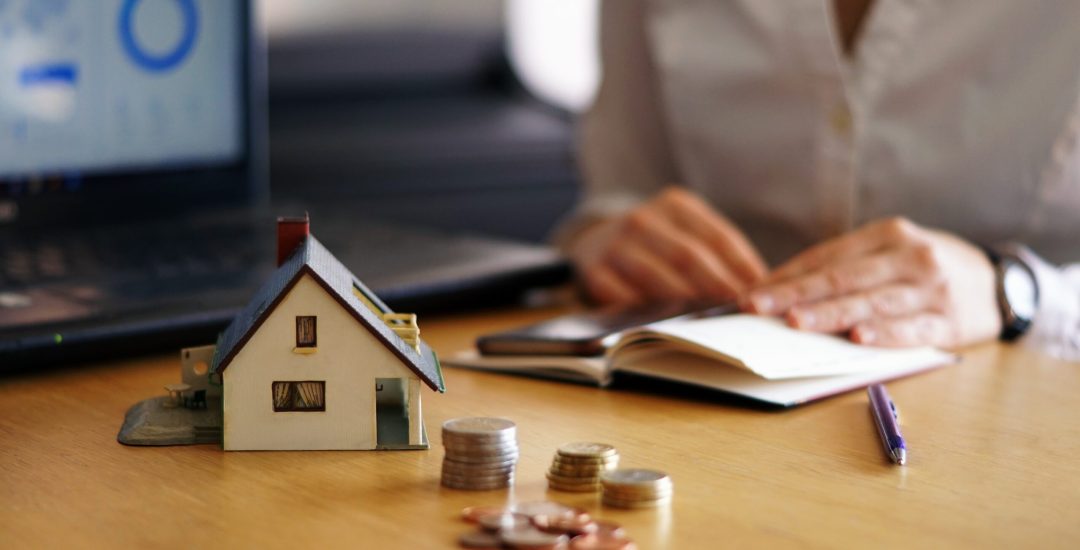 A closeup shot of a person thinking of buying or selling a house