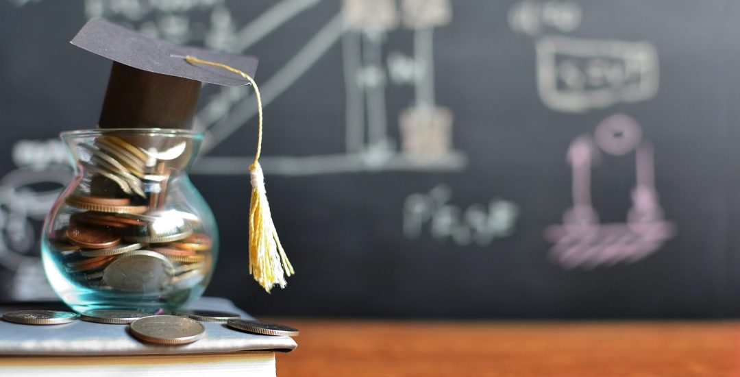 Hat,Graduation,Model,On,Coins,Saving,For,Concept,Investment,Education