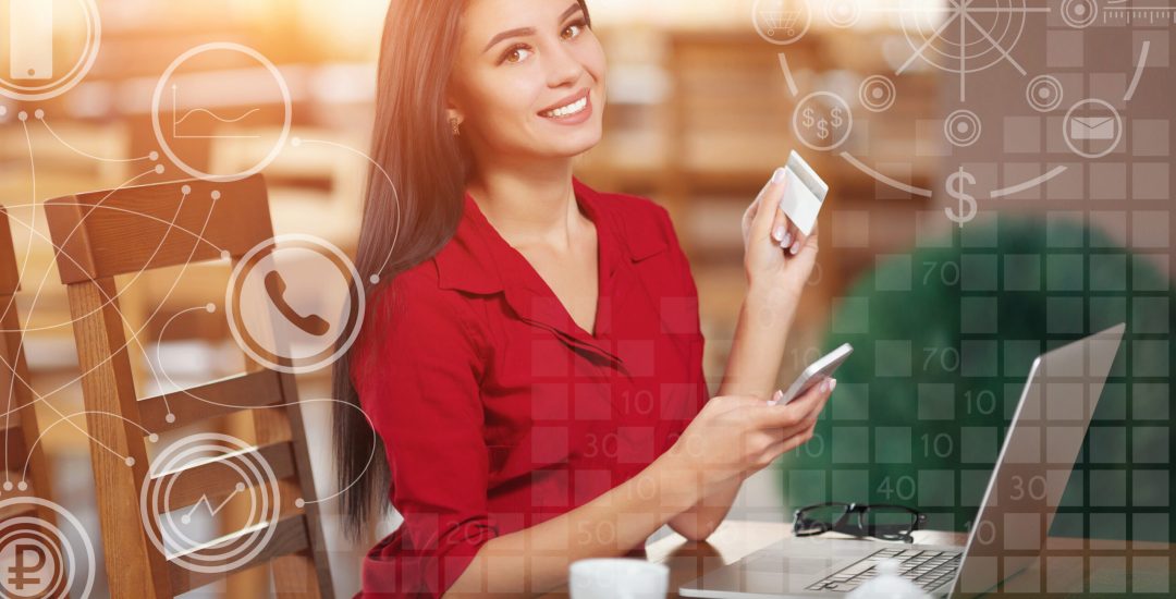 Young business woman holding mobile phone and credit card. Woman pays for a purchase with credit card and looking in camera. Purchase and shopping online. Business infographic