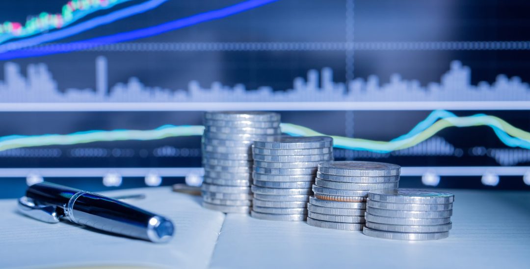 Stack of money coin with trading graph. financial investment concept use for background.