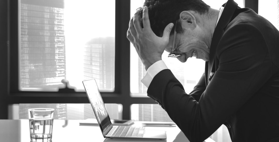 Stressed young businessman overworking
