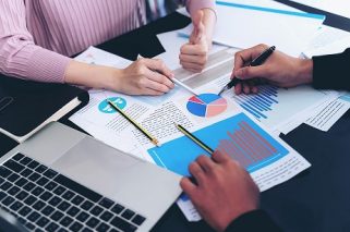 close up hand of  Business man busy at office desk  on  Notebook and documents  working  , business concept