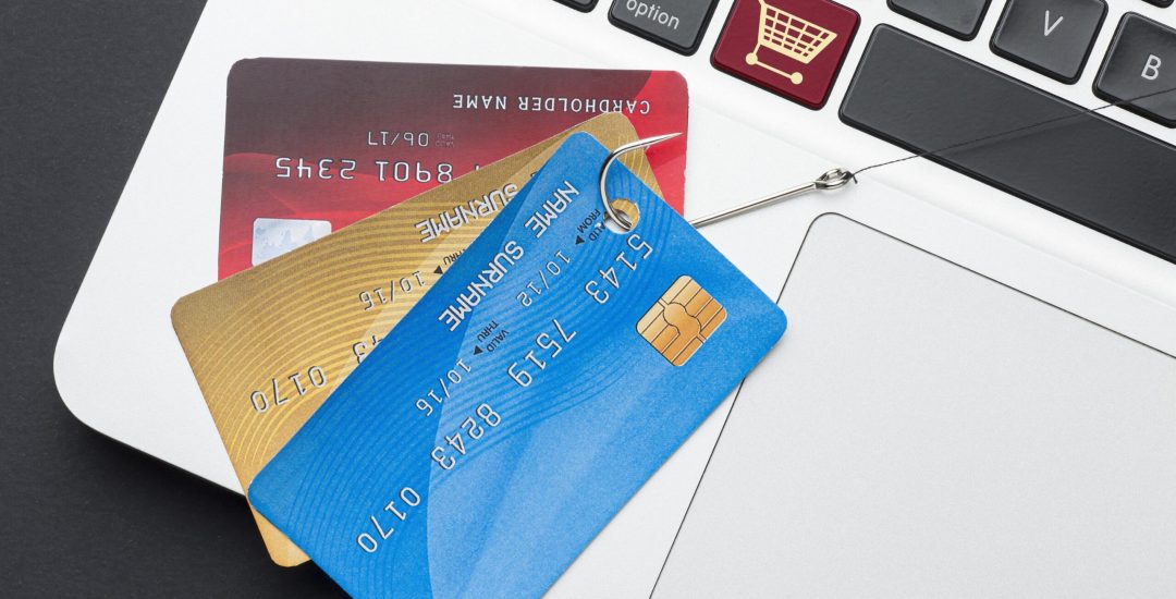 top-view-of-laptop-with-credit-card-and-phishing-hook