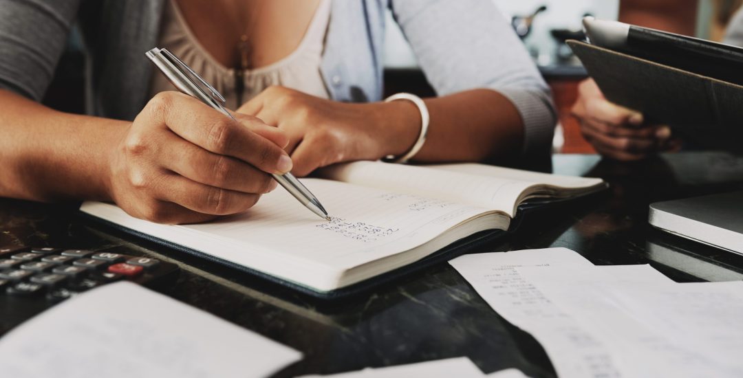 Cropped image of woman analyzing budget and counting income