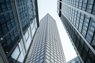 A vertical low angle shot of high rise skyscrapers in a glass facade in Frankfurt, Germany